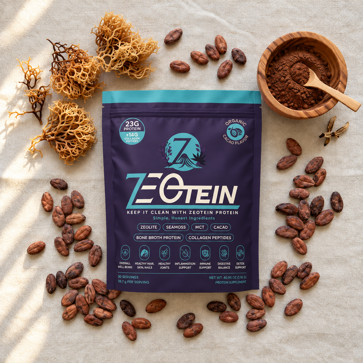 Zeotein Cacao Protein Powder on beige fabric surrounded by cacao beans, a wooden bowl of cacao powder, and dried sea moss